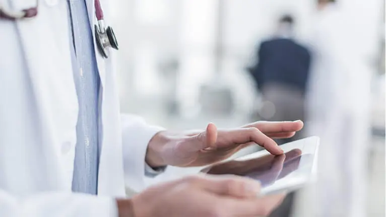 Doctor holding ipad in hospital